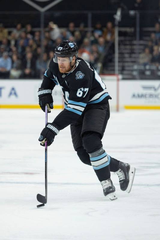 Utah Hockey Club left wing Lawson Crouse (67) moves the puck against Vegas Golden Knights durin ...