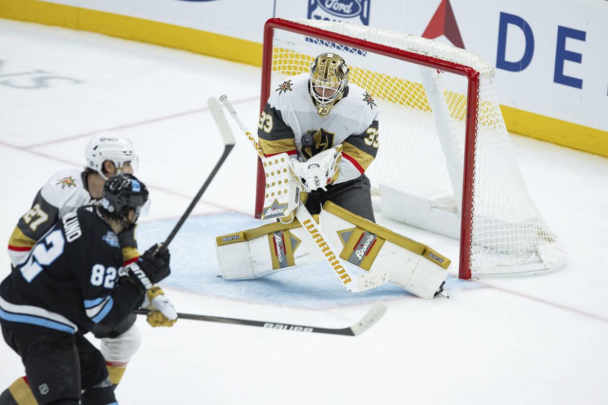 Vegas Golden Knights goaltender Adin Hill (33) saves the puck against Utah Hockey Club center K ...