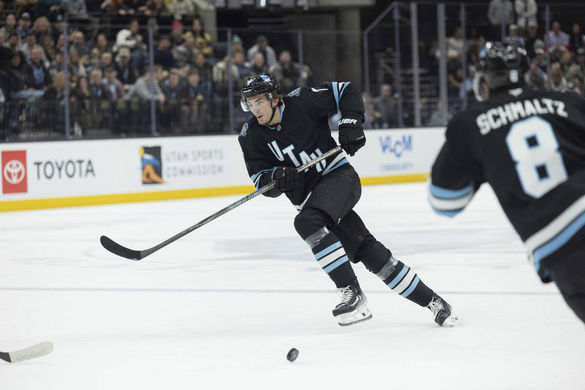 Utah Hockey Club defenseman Michael Kesselring (7) passes the puck to teammate center Nick Schm ...