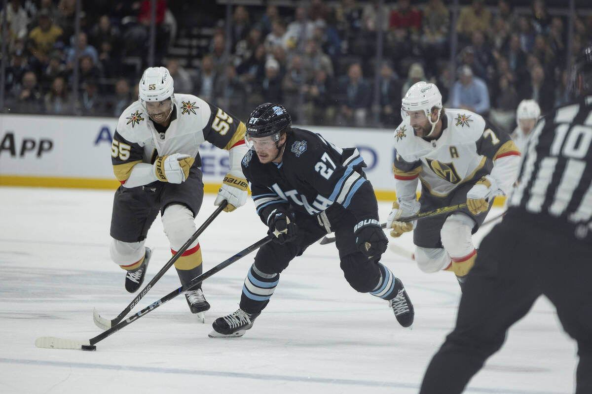 Utah Hockey Club center Barrett Hayton (27) moves the puck against Vegas Golden Knights right w ...