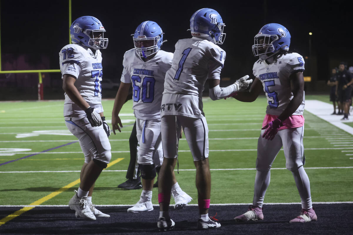 Centennial running back Khy Harris (5) celebrates his touchdown with Jayden Thomas (1) during a ...