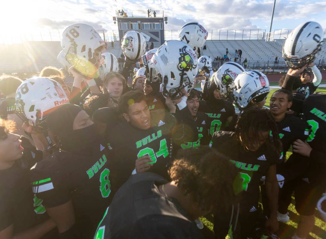 SLAM Academy celebrates after winning the 3A state semifinal football game against Churchill Co ...