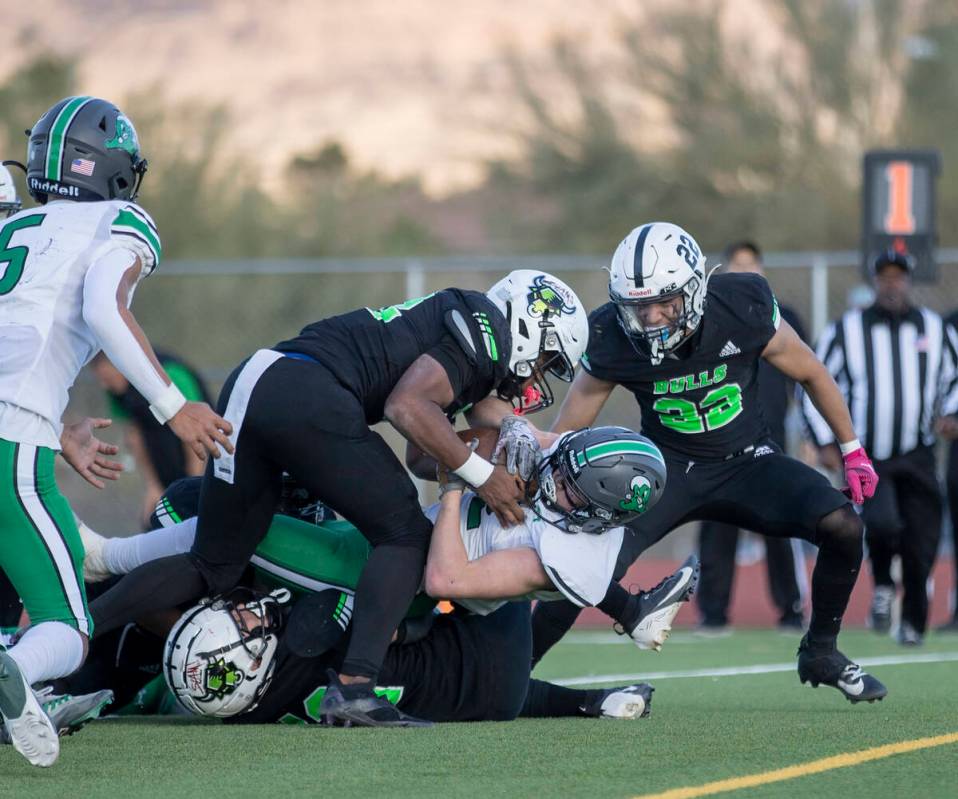 SLAM Academy senior Damien Nevil, left, tackles Churchill County junior Carson Melendy, right, ...