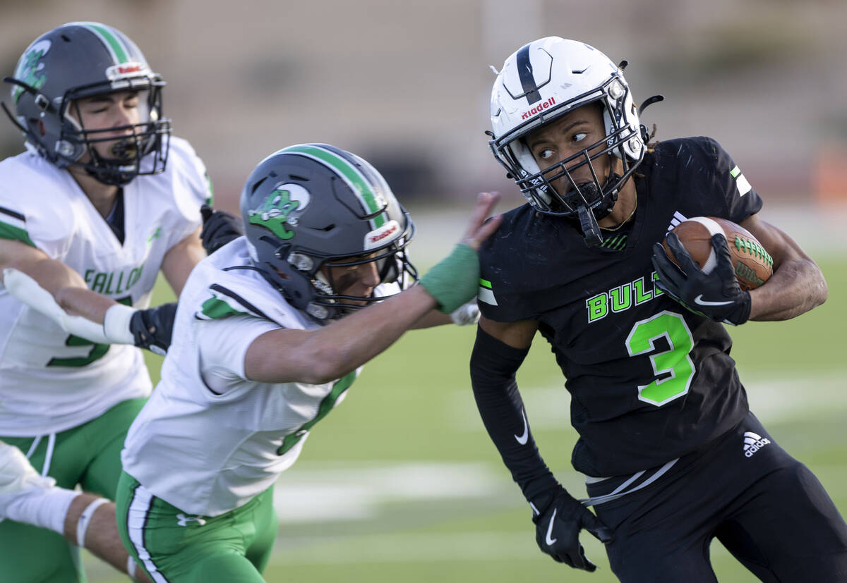 SLAM Academy senior Choy'ce Meloncon (3) avoids defensemen during the 3A state semifinal footba ...