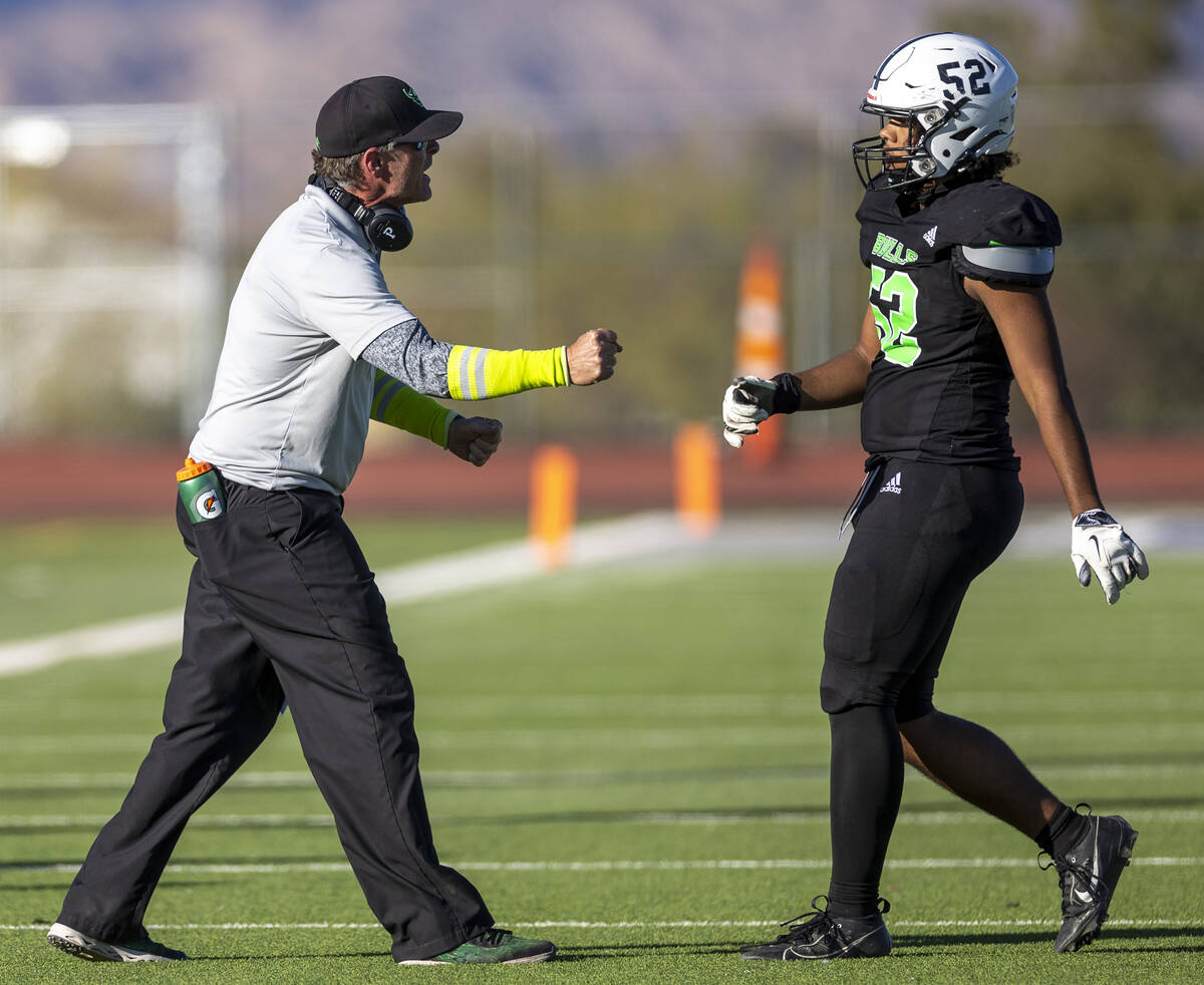 SLAM Academy Head Coach Mike Cofer speaks to senior Jayden Sykes (52) during the 3A state semif ...