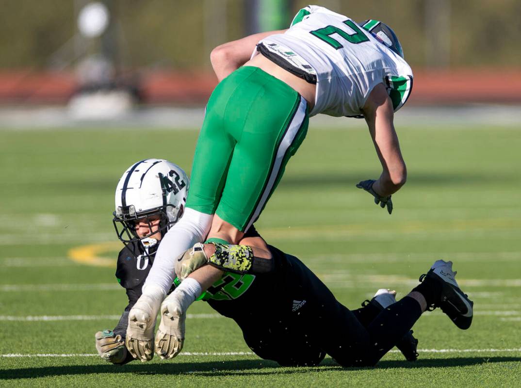 SLAM Academy linebacker Kyler Proudfoot (42) tackles Churchill County junior Carson Melendy (2) ...