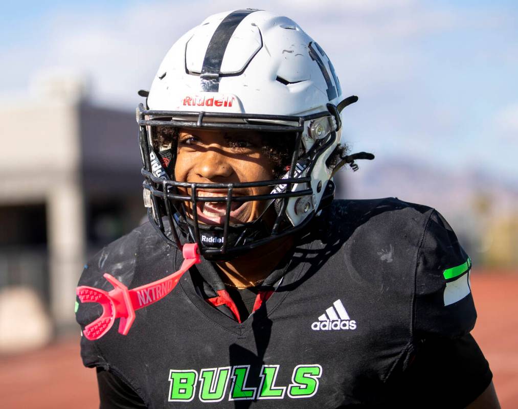 SLAM Academy senior Damien Nevil (12) runs toward the sideline, smiling after scoring a touchdo ...