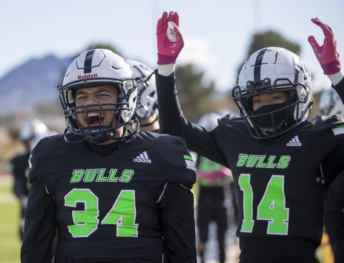 SLAM Academy freshman Czar Soto (34) and freshman Chance Meloncon (14) celebrate after a touchd ...