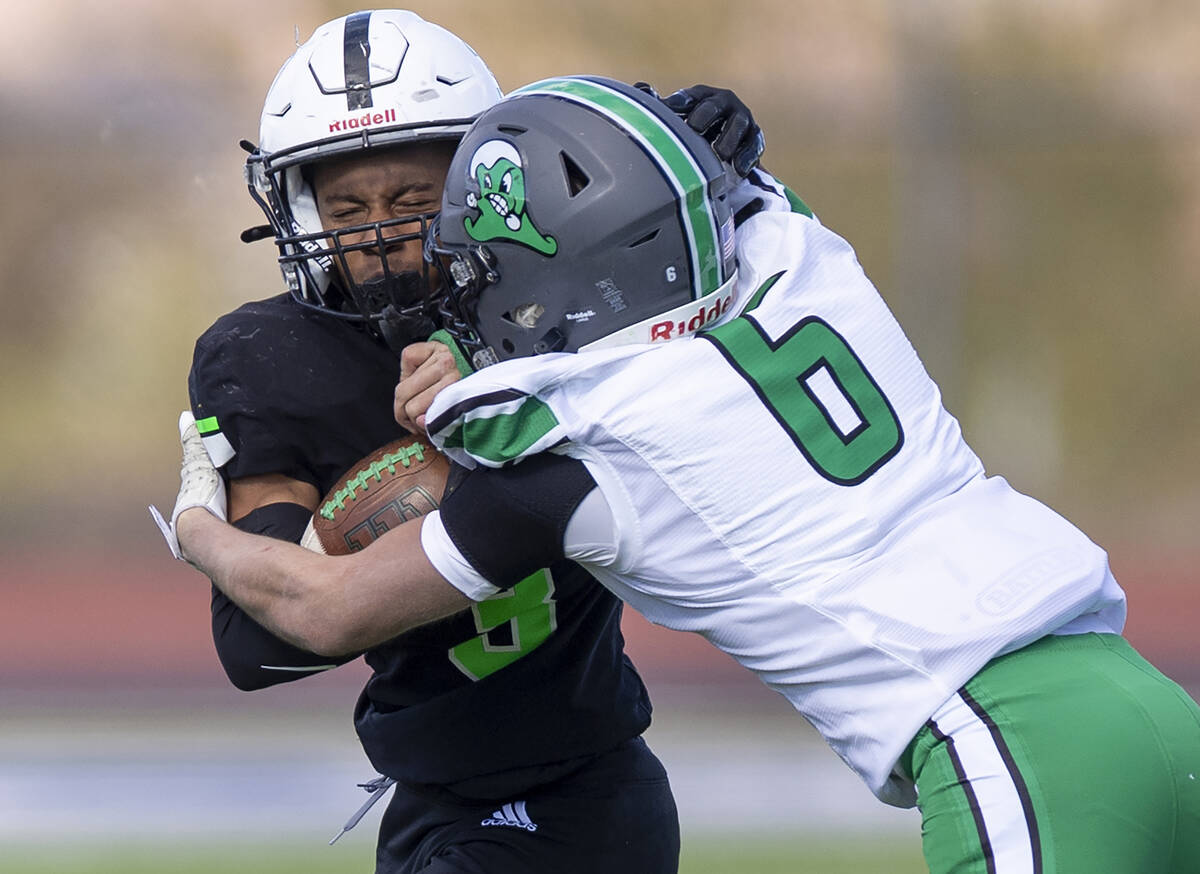 SLAM Academy senior Choy'ce Meloncon, left, is pushed by Churchill County junior Brenan Alves, ...