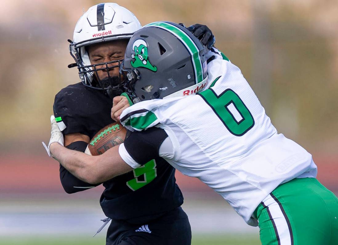 SLAM Academy senior Choy'ce Meloncon, left, is pushed by Churchill County junior Brenan Alves, ...