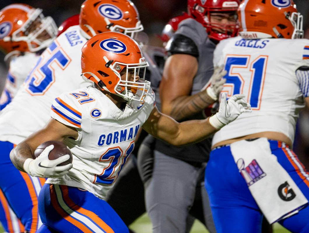 Bishop Gorman running back Jonathan Coar (21) runs the ball during the high school football gam ...