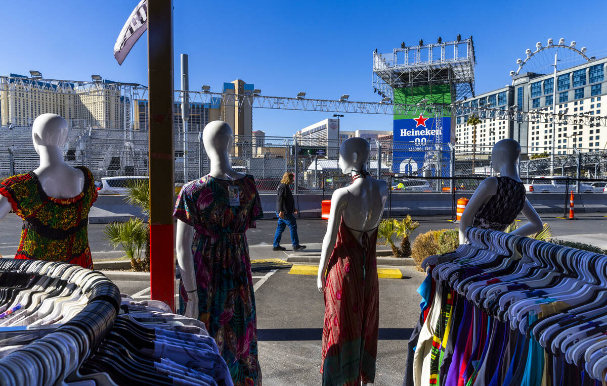 A pedestrian walks past Las Vegas Souvenirs & Gifts as grandstands and race barriers are no ...