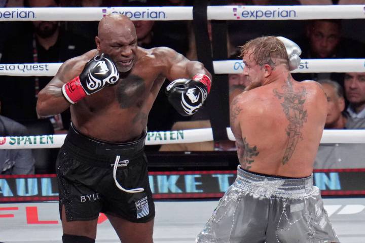 Mike Tyson, left, fights Jake Paul during their heavyweight boxing match, Friday, Nov. 15, 2024 ...