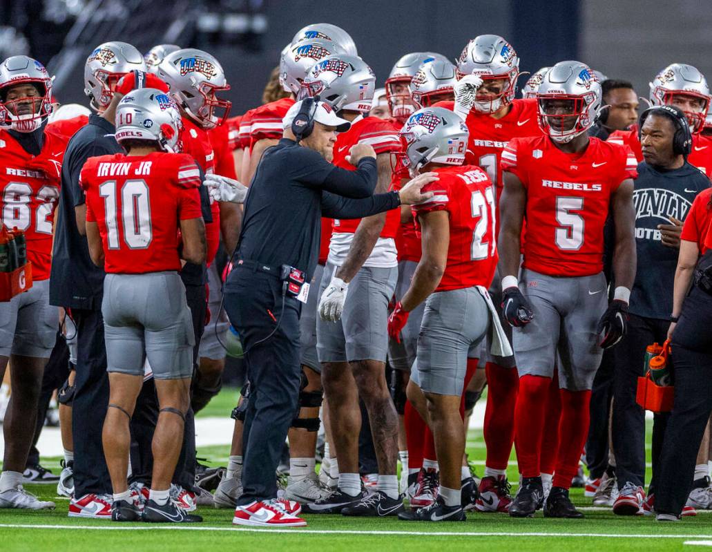 UNLV head coach Barry Odom congratulates UNLV wide receiver Jacob De Jesus (21) on another grea ...