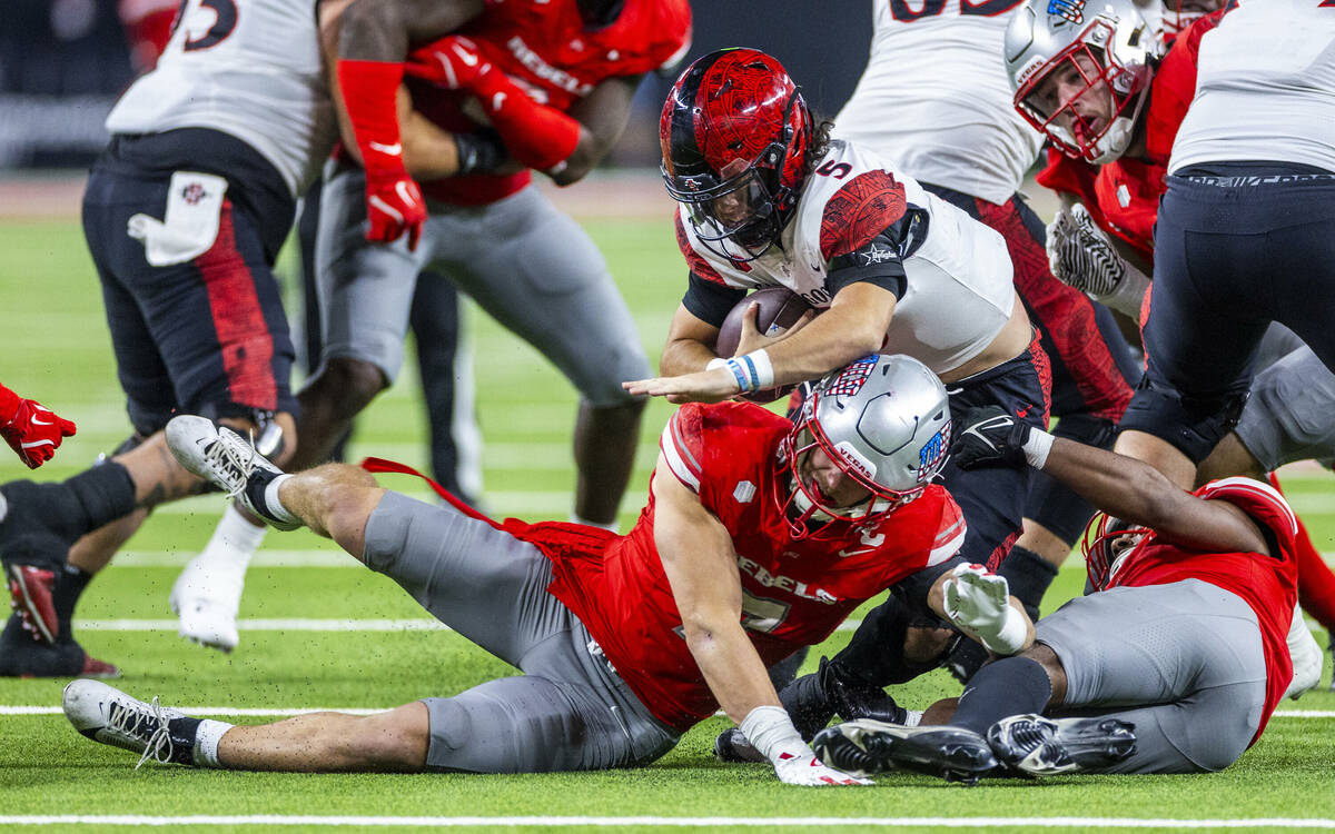 San Diego State Aztecs quarterback Danny O'Neil (5) is sacked by UNLV linebacker Jackson Woodar ...