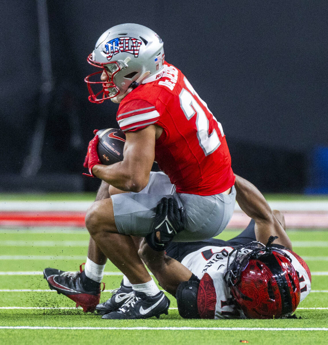 UNLV wide receiver Jacob De Jesus (21) secures another catch as San Diego State Aztecs safety D ...