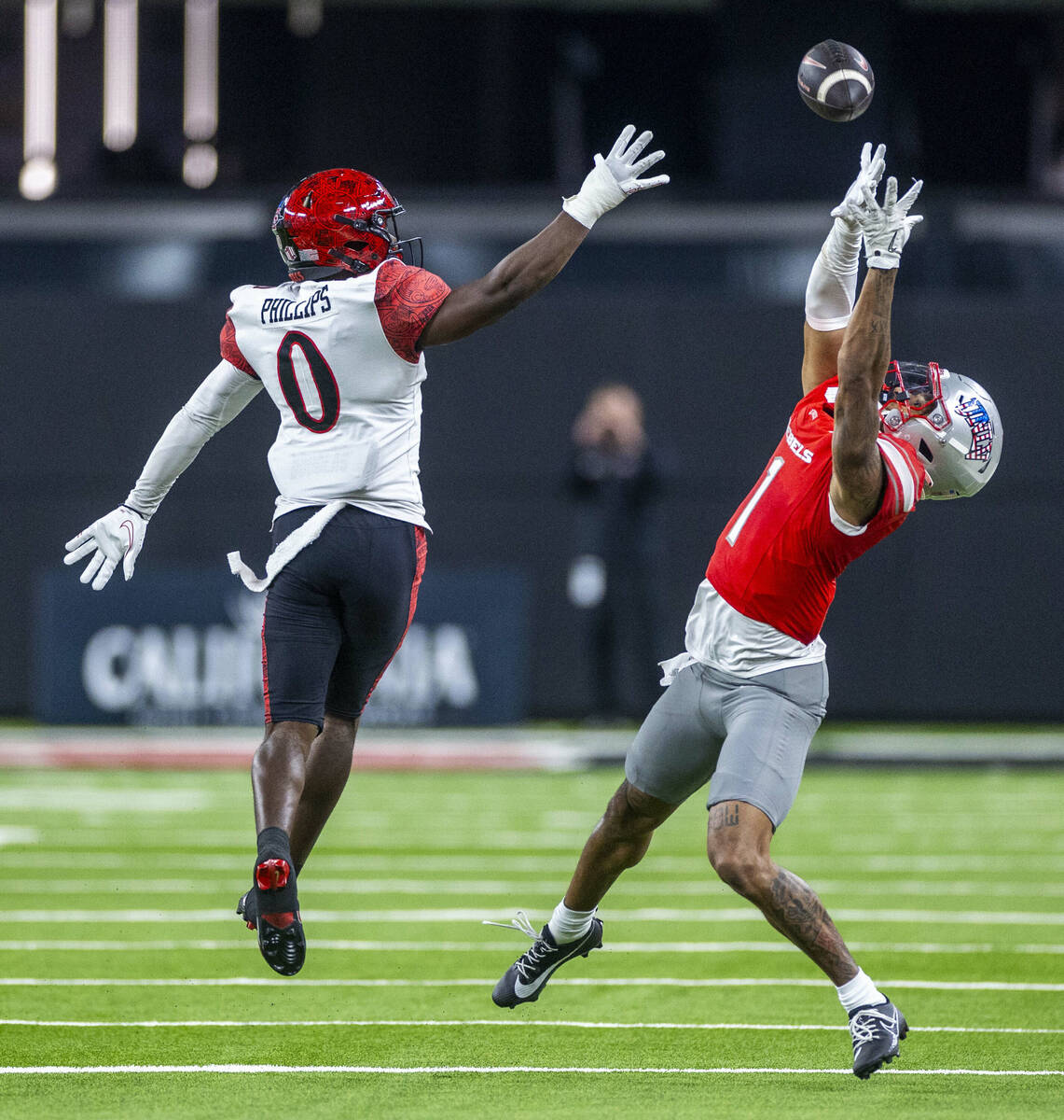 UNLV wide receiver Casey Cain (1) elevates for a reception attempt past San Diego State Aztecs ...