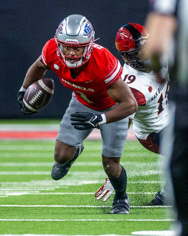 UNLV defensive back Jalen Catalon (1) runs back an interception past San Diego State Aztecs wid ...