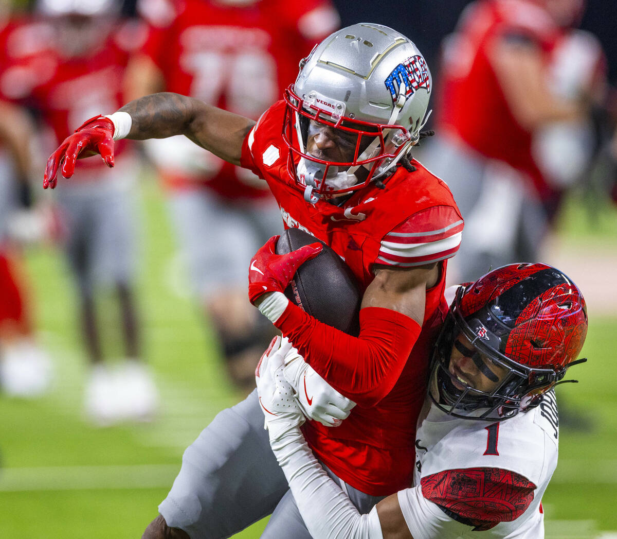 UNLV wide receiver Ricky White III (11) is wrapped up after a catch by San Diego State Aztecs s ...