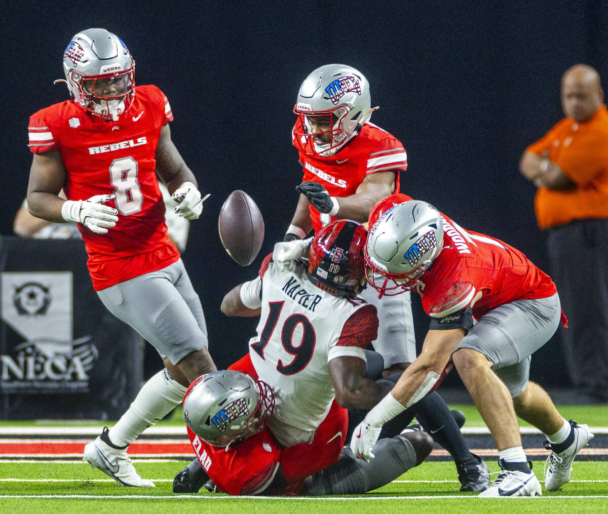 UNLV linebacker Jackson Woodard (7) jars the ball loose from San Diego State Aztecs wide receiv ...