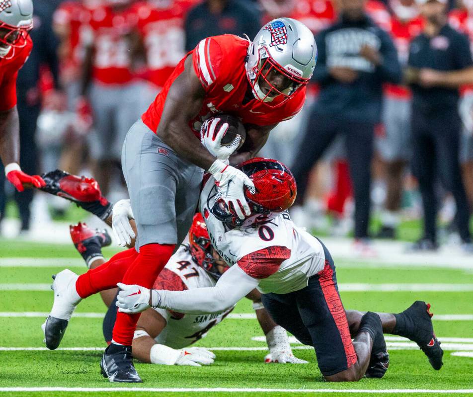 UNLV running back Greg Burrell (5) puts a move on San Diego State Aztecs edge Trey White (47) p ...