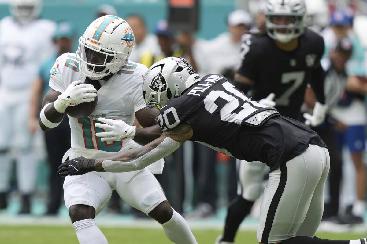 Las Vegas Raiders safety Isaiah Pola-Mao (20) goes after Miami Dolphins wide receiver Tyreek Hi ...