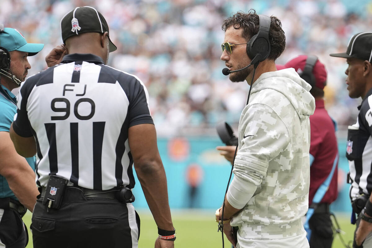 Miami Dolphins head coach Mike McDaniel talks to side judge Anthony Flemming (90) during the fi ...