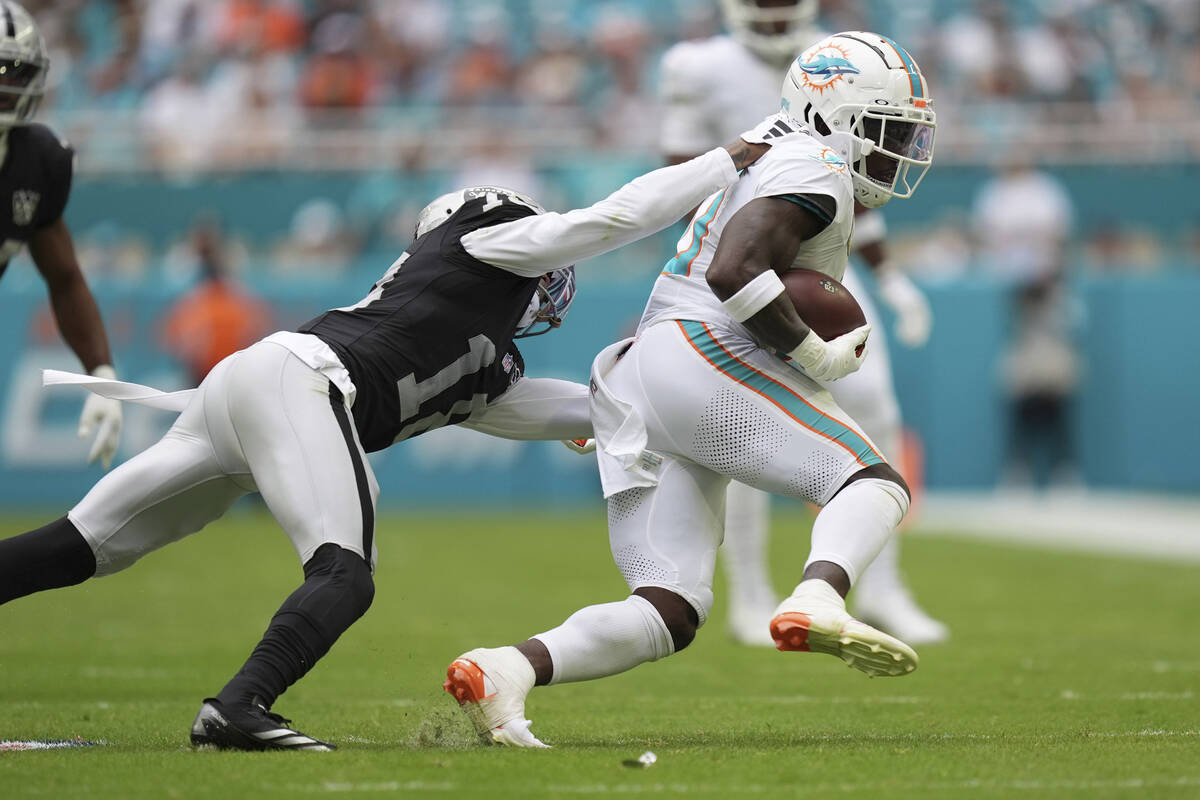 Las Vegas Raiders cornerback Jack Jones (18) grabs Miami Dolphins wide receiver Tyreek Hill (10 ...