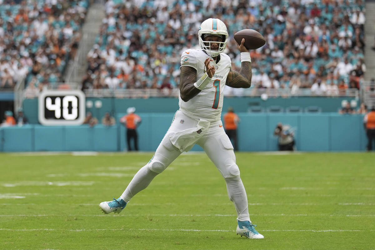 Miami Dolphins quarterback Tua Tagovailoa (1) throws a touchdown pass to wide receiver Tyreek H ...