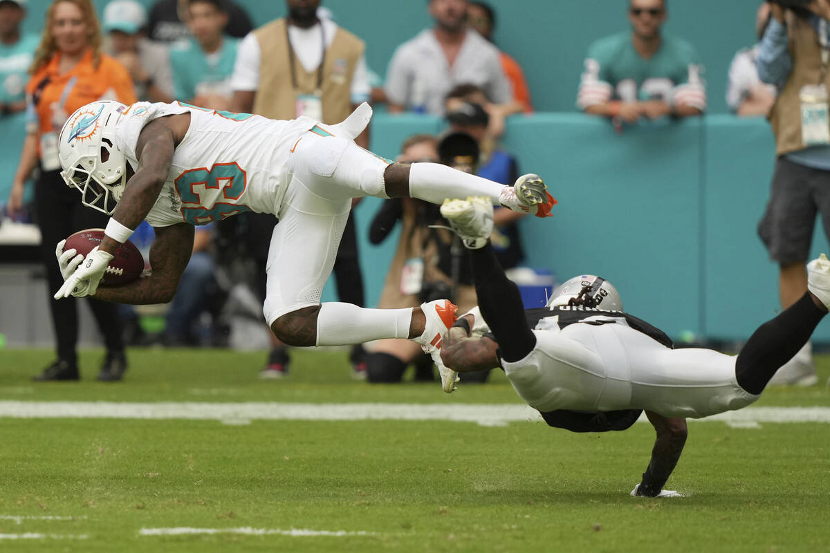 Las Vegas Raiders wide receiver DJ Turner (19) tackles Miami Dolphins wide receiver Malik Washi ...