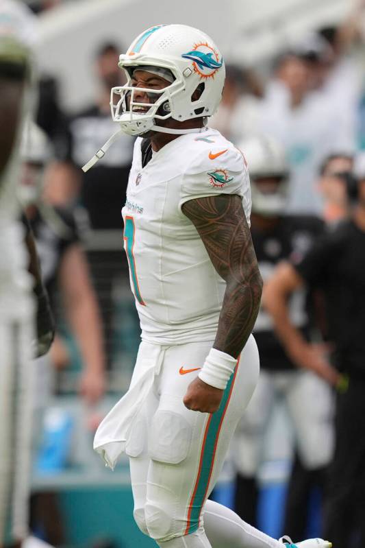 Miami Dolphins quarterback Tua Tagovailoa (1) celebrates a touchdown during the second half of ...