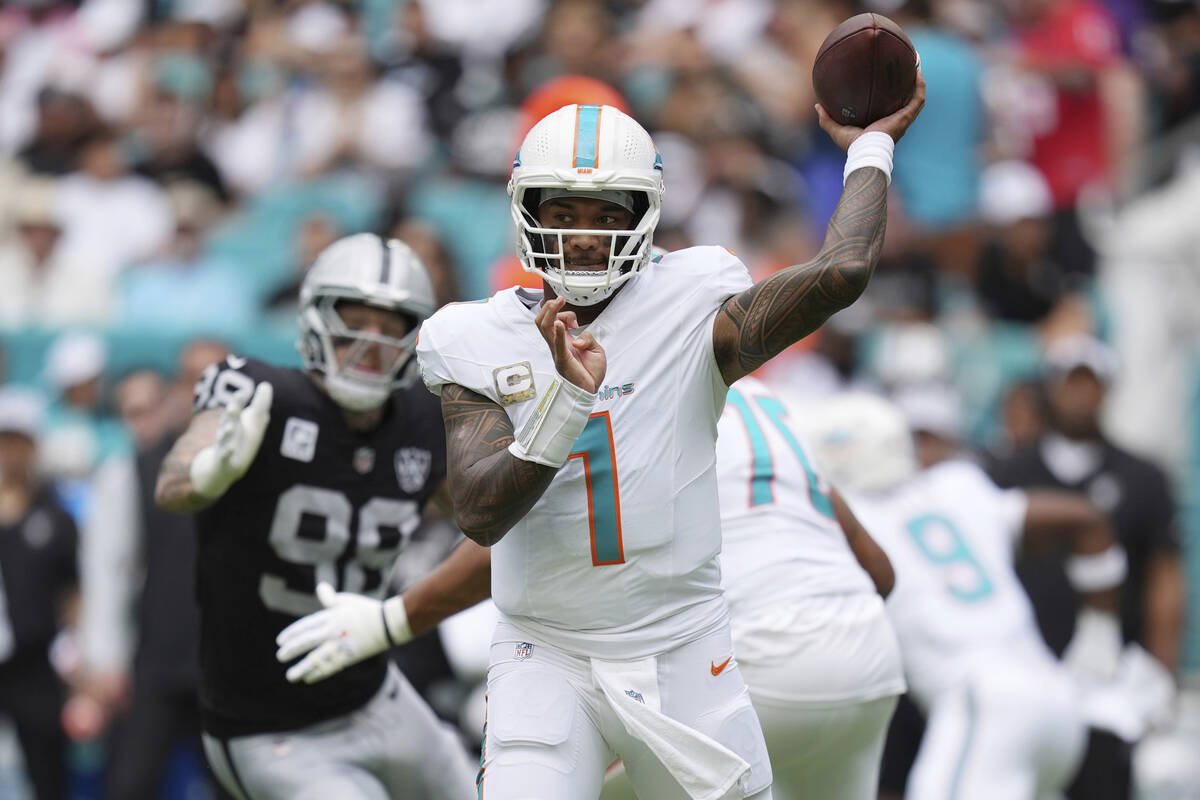 Miami Dolphins quarterback Tua Tagovailoa (1) aims a pass during the first half of an NFL footb ...