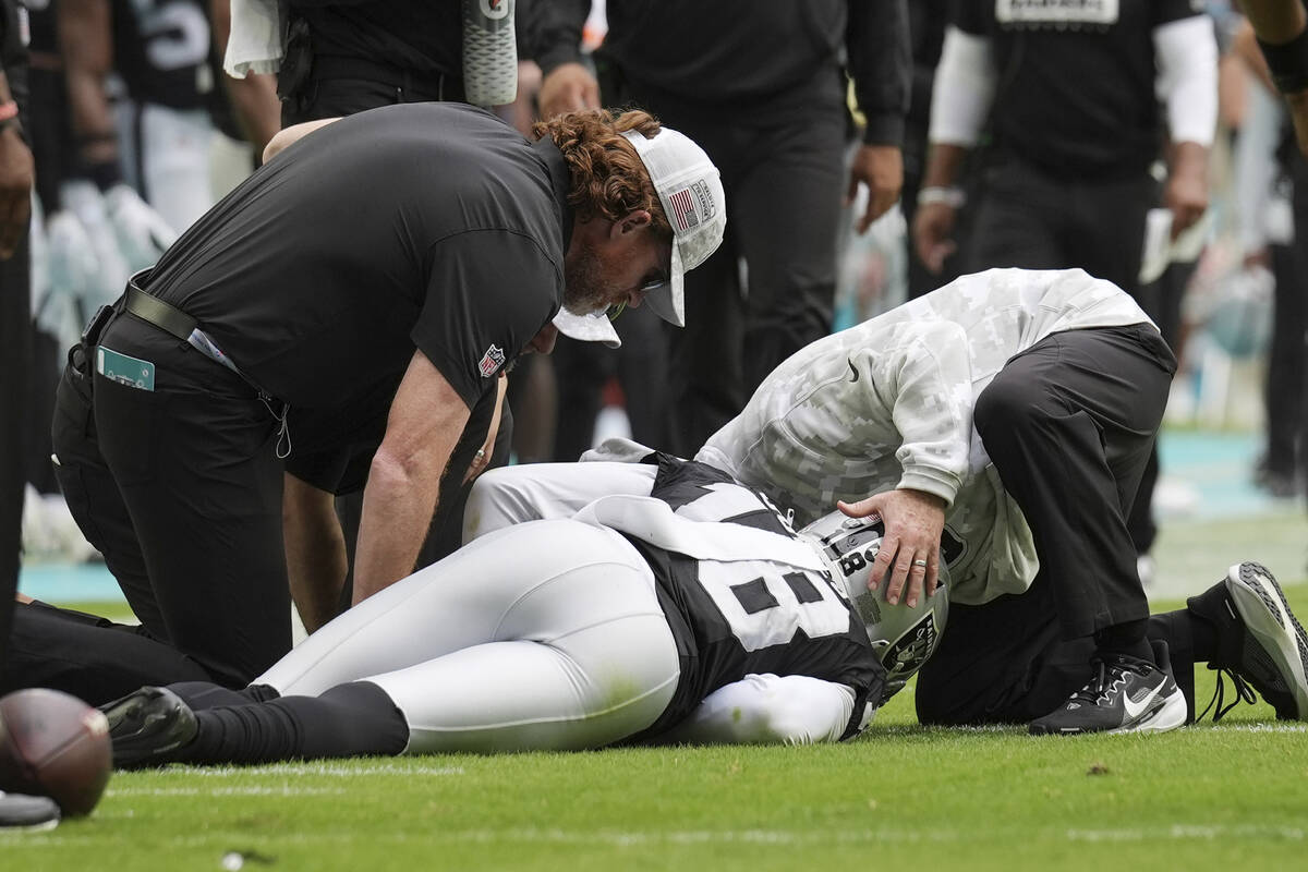 Las Vegas Raiders cornerback Jack Jones (18) is assisted on the field during the second half of ...