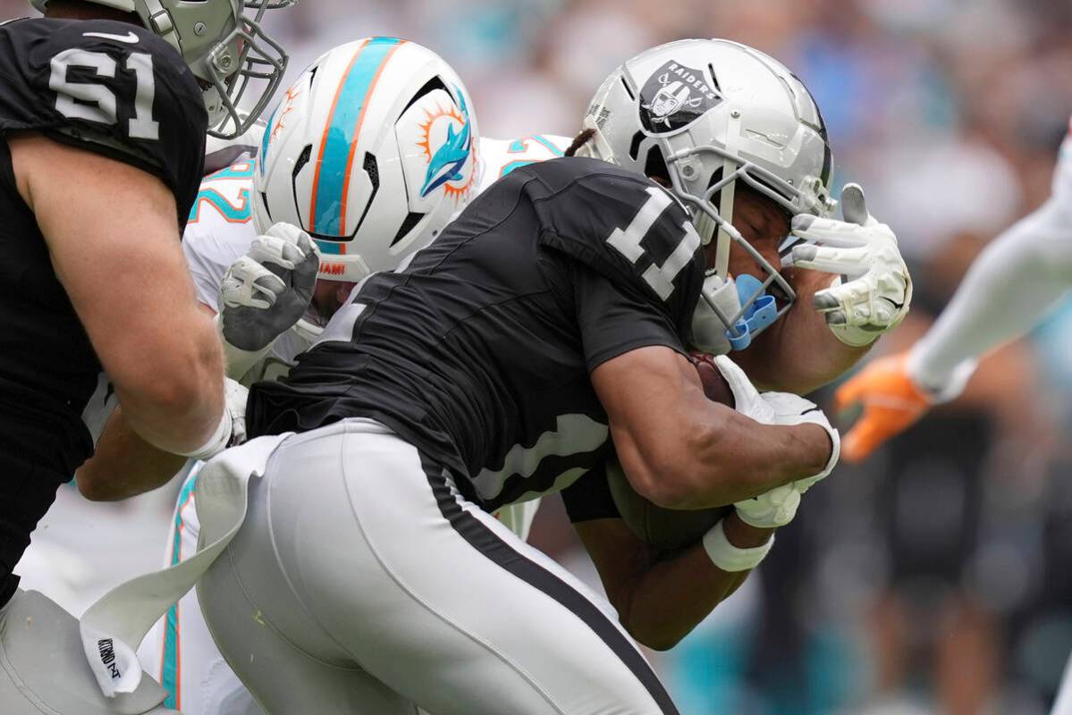 Miami Dolphins defensive tackle Zach Sieler (92) grabs Las Vegas Raiders wide receiver Tre Tuck ...