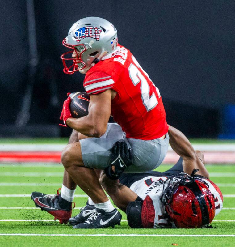 UNLV wide receiver Jacob De Jesus (21) secures another catch as San Diego State Aztecs safety D ...