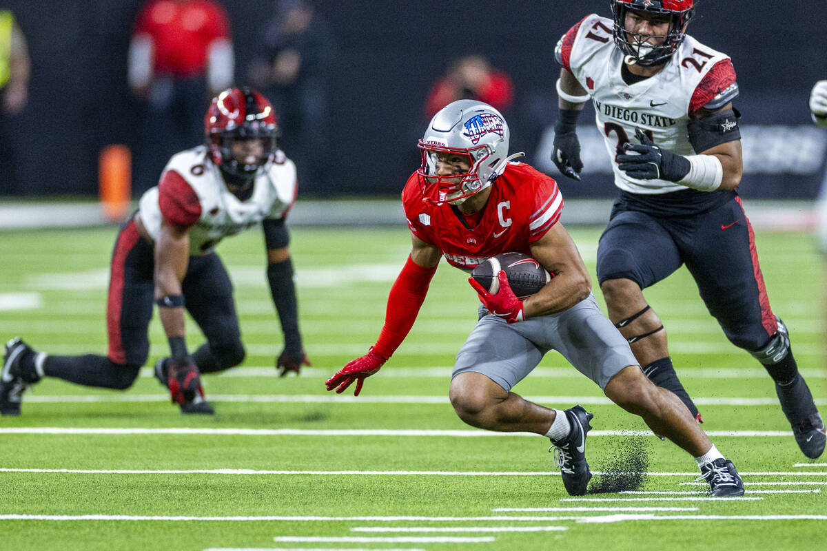 UNLV wide receiver Jacob De Jesus (21) cuts up field after another erection trailed by San Dieg ...