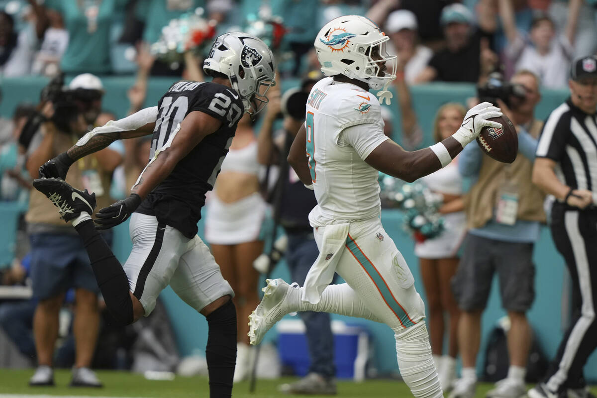 Miami Dolphins tight end Jonnu Smith (9) scores a touchdown as Las Vegas Raiders safety Isaiah ...