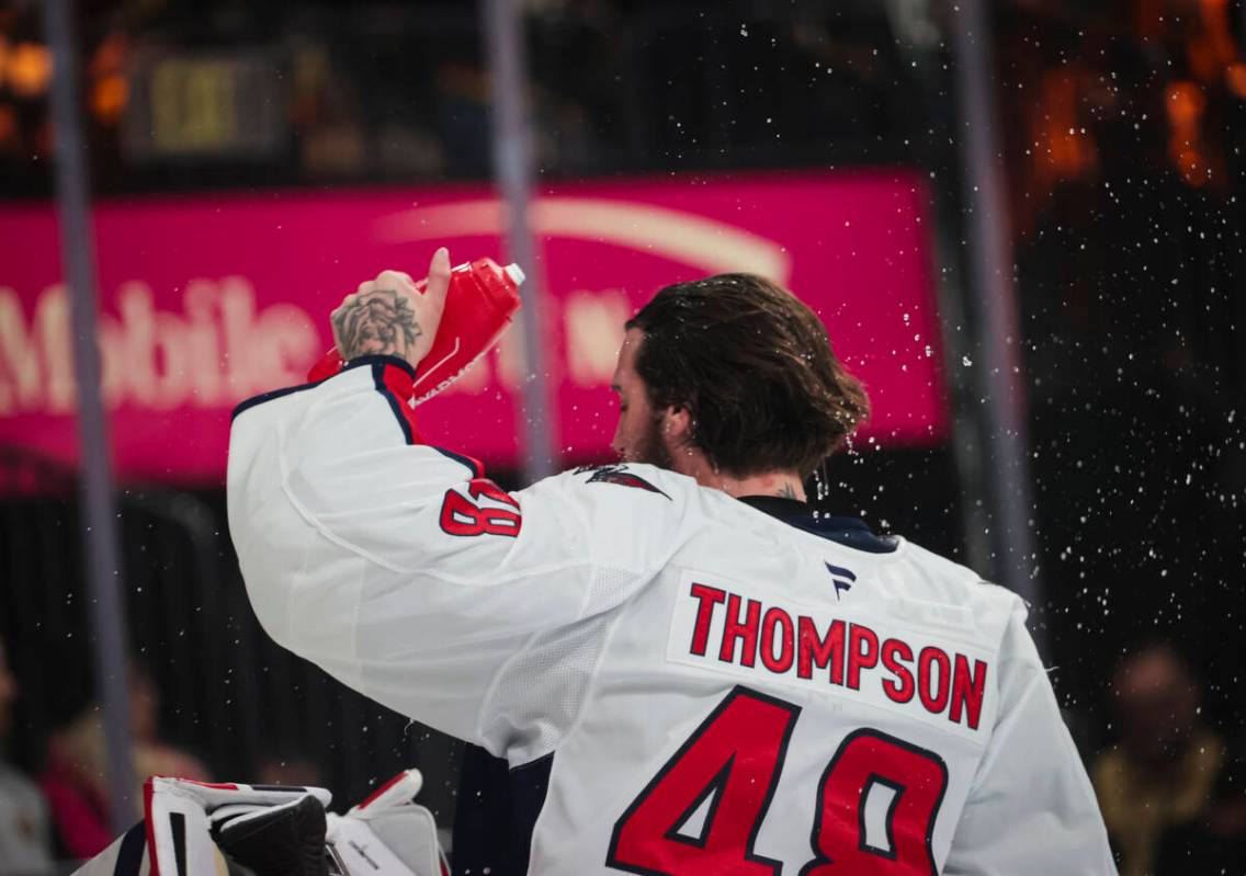 Washington Capitals goaltender Logan Thompson (48) sprays himself with water during the first p ...