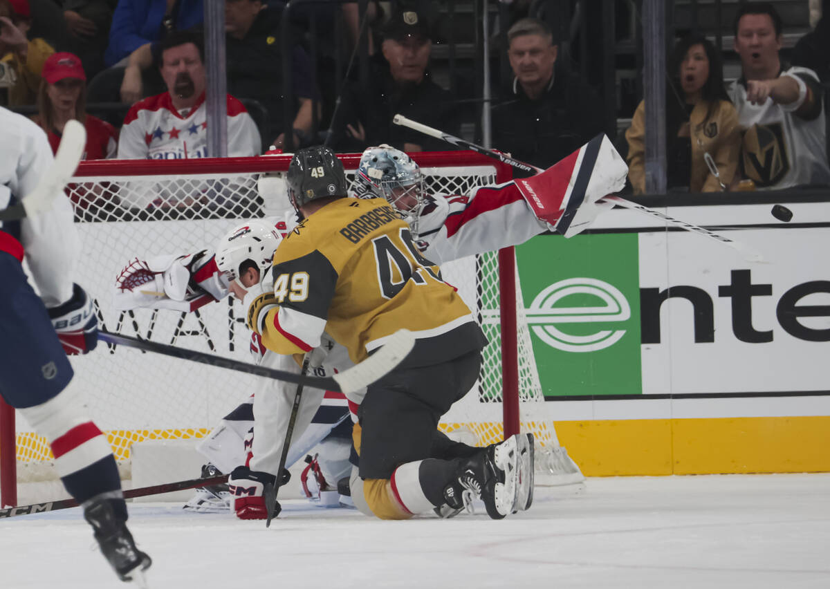 Washington Capitals goaltender Logan Thompson (48) deflects the puck in front of Golden Knights ...