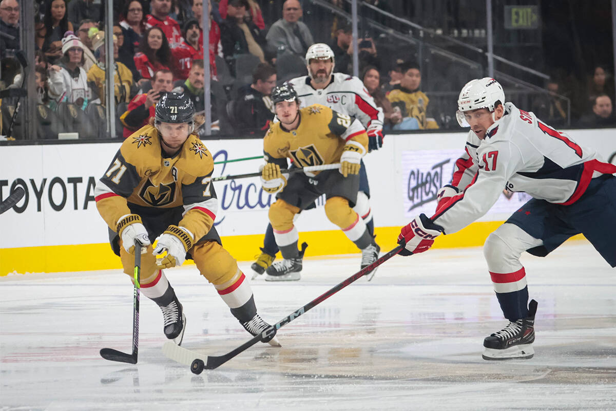 Washington Capitals center Dylan Strome (17) steals the puck from Golden Knights center William ...