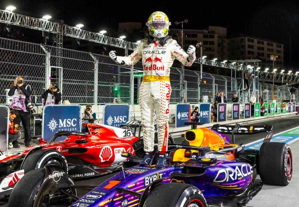 Red Bull Racing driver Max Verstappen celebrates his win atop his Red Bull Racing car following ...