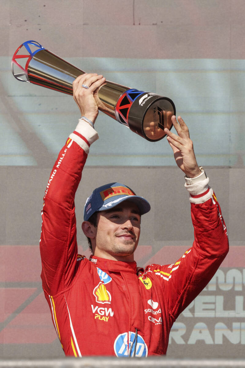 Ferrari driver Charles Leclerc, of Monaco, holds the trophy after winning the U.S. Grand Prix a ...