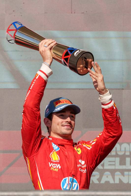 Ferrari driver Charles Leclerc, of Monaco, holds the trophy after winning the U.S. Grand Prix a ...