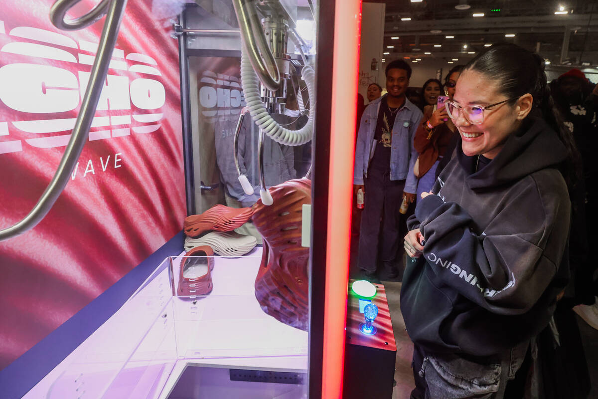 Paolina Mendez smiles as she successfully gets a pair of Echo Wave crocs from a claw machine du ...