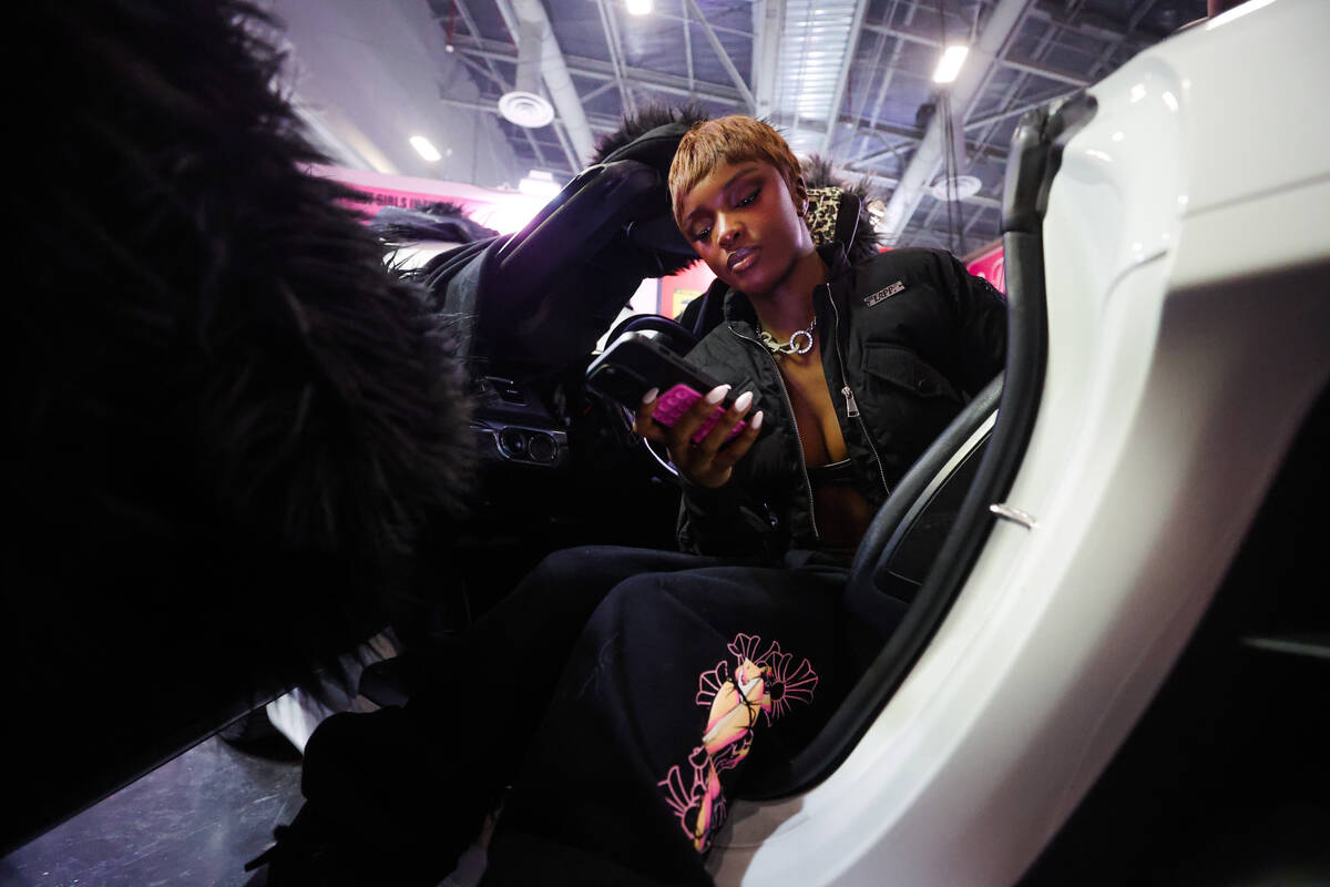 Leomie Anderson sits inside a car at a booth during ComplexCon at the Las Vegas Convention Cent ...