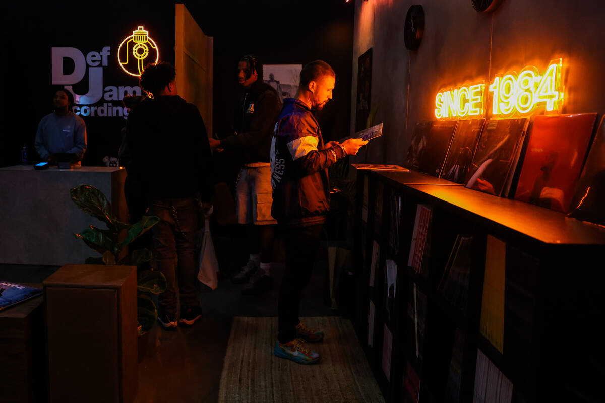 An attendee looks at records inside the Def Jam booth during ComplexCon at the Las Vegas Conven ...