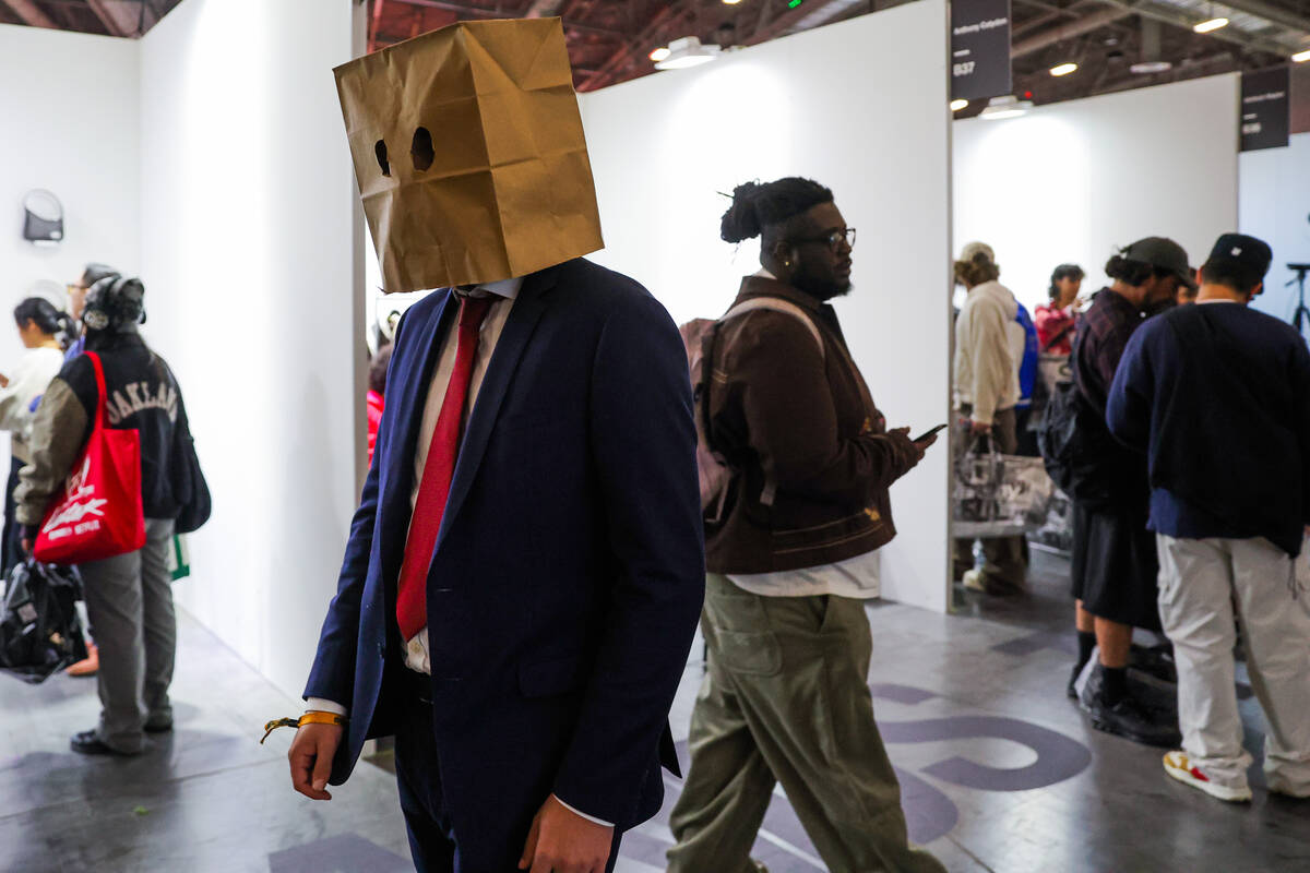 An attendee wearing a paper bag walks through rows of shops during ComplexCon at the Las Vegas ...