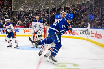 Toronto Maple Leafs right wing Ryan Reaves (75) collides with Edmonton Oilers defenseman Darnel ...