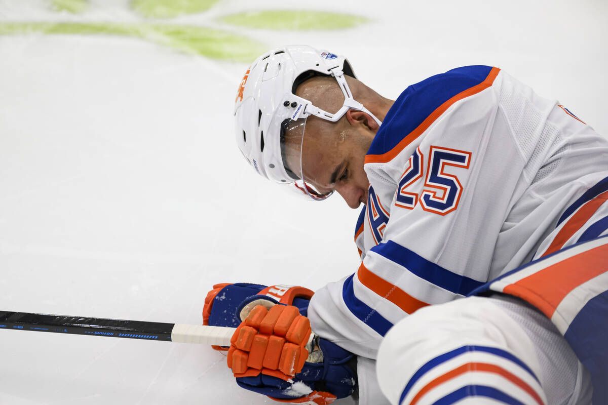 Edmonton Oilers defenseman Darnell Nurse (25) lays on the ice after colliding with Toronto Mapl ...