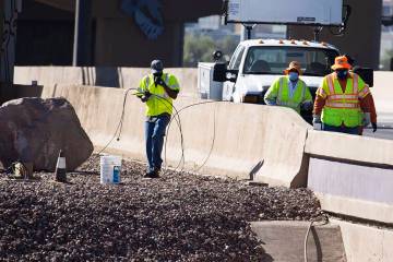 Nevada Department of Transportation workers replace copper wire after Spaghetti Bowl lights wer ...